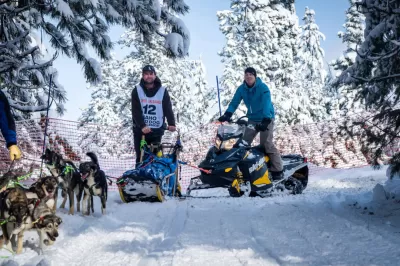 Idaho Sled Dog Challenge Returns Jan. 21-Feb. 3 : MCCALL, Idaho (Jan. 9, 2023) -- SNOW ROVERS -- The Idaho Sled Dog Challenge is returning to the West Central Mountains of Idaho Jan. 21-Feb. 2, 2023, for its fifth year. Part of the Rocky Mountain Triple Crown, the race features world-class mushers and is an Iditarod and Yukon Quest qualifier. Pictured here on Jan. 30, 2020, a volunteer snowmobiler (right) escorts McCall, Idaho, musher Kevin Daugherty (left) and his team to the official start of the 100-mile race, in which he finished in 10th place. Organizers could not stage the races without help from Valley County's grooming team and local snowmobilers, because there's so much vertical gain the dogs can't pull sleds uphill in deep snow. Although he didn't compete in last year's event, Daugherty is registered for this year's 100-mile race. (Photo by Melissa Shelby)