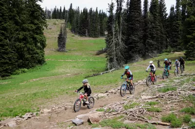 SKI IDAHO THIS SUMMER : A family enjoys the "Lakeview Vista" mountain bike trail at Brundage Mountain Resort. Eleven of Idaho's 19 ski areas offer mountain biking in the summer, as well as scenic chairlift and gondola rides, hiking and trail running, disc golf, zipline tours, horseback riding, and more. Visit skiidaho.us for more details. (Photo by Gary Peterson for Ski Idaho)