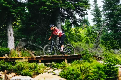 SKI IDAHO THIS SUMMER : A rider crosses a boardwalk on one of Schweitzer's 40 miles of mountain bike trails last summer. Eleven of Idaho's 19 ski areas offer mountain biking in the summer, as well as scenic chairlift and gondola rides, hiking and trail running, disc golf, zipline tours, horseback riding, and more. Visit skiidaho.us for more details. (Photo by Gary Peterson for Ski Idaho)